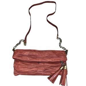 Avant Premiere Rust Colored Magnetic Roll Down Crossbody Bag W/Zip Tassel detail